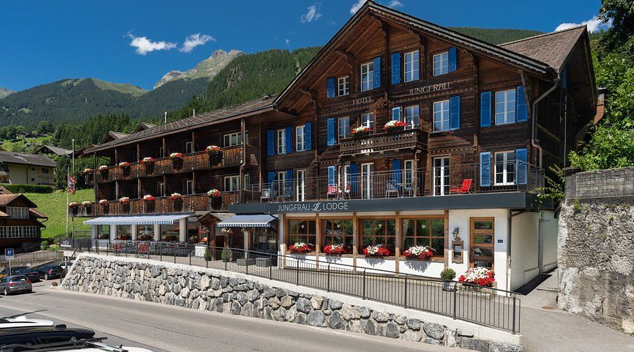 The traditional wooden facade of the Jungfrau Lodge hotel in Switzerland.